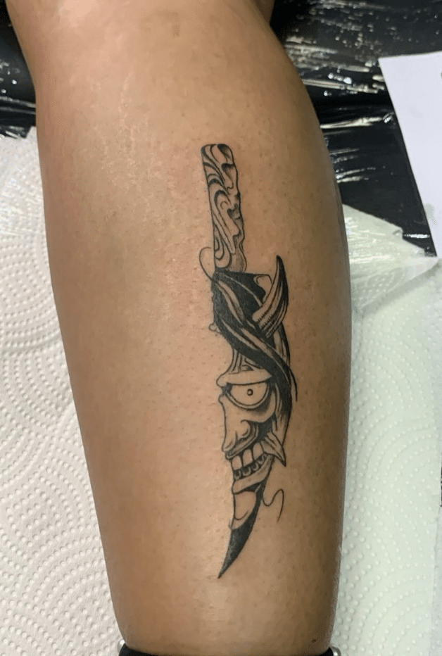 Mask In Blade Tattoo